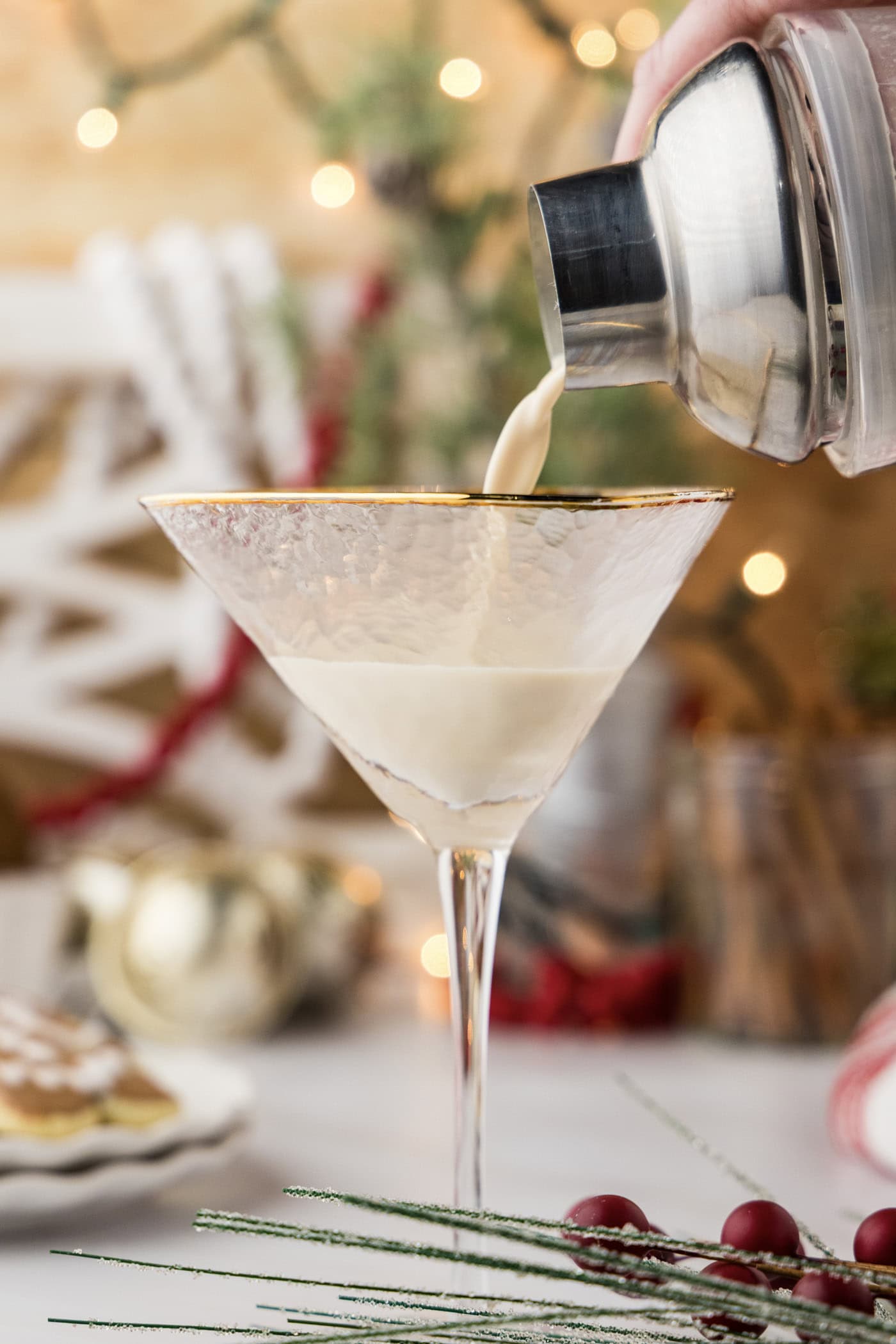 straining gingerbread martini into a martini glass