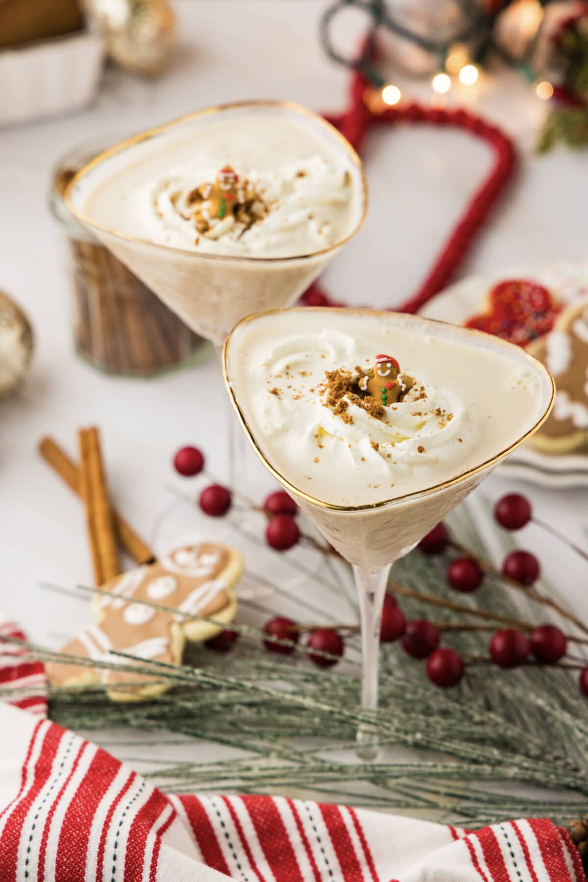 Two Gingerbread Martinis surrounded by gingerbread cookies