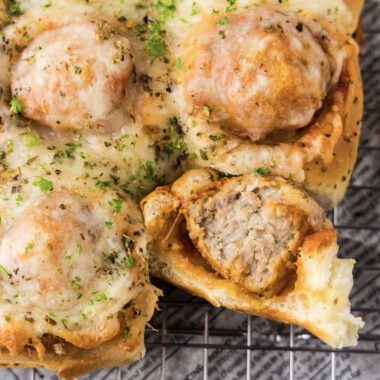 Close up photo of a Meatball Slider with a bite taken out of it