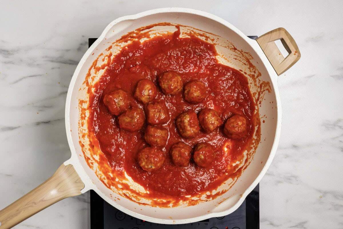 meatballs in a skillet with marinara sauce