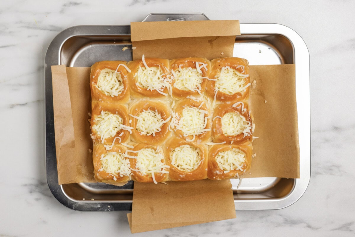 mozzarella cheese added to holes cut out of buns