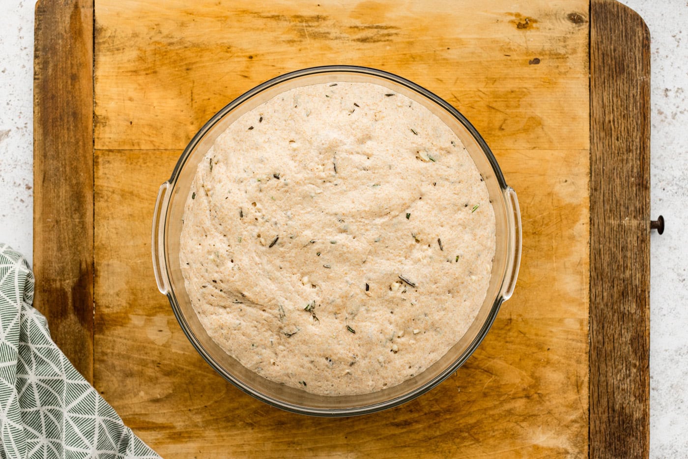 rosemary bread dough doubled in size in a bowl