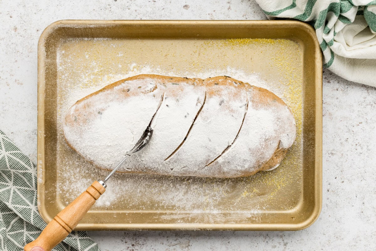 Pastry wheel making slits on top of risen dough
