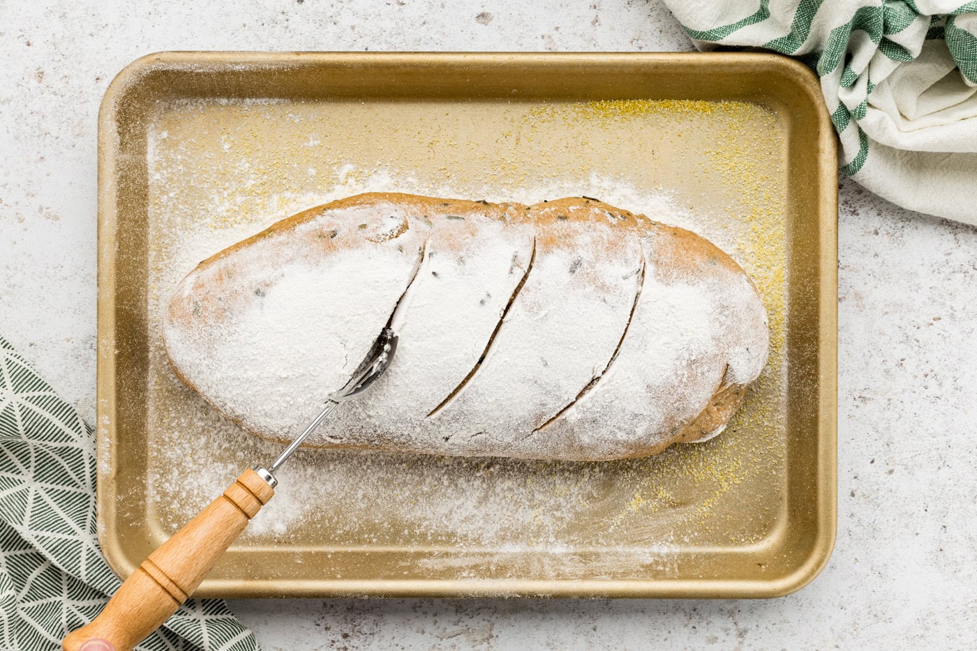 Pastry wheel making slits on top of risen dough