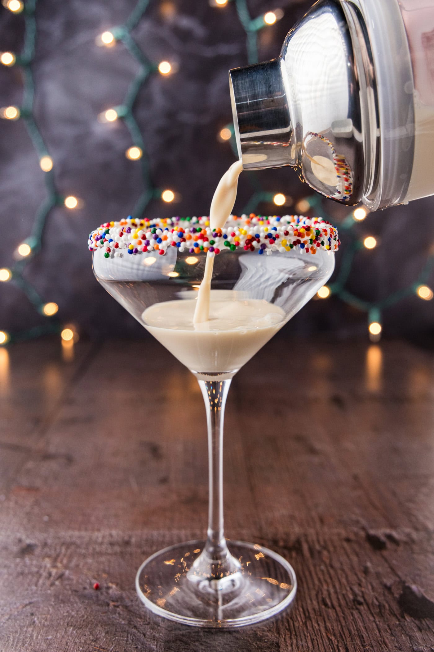 straining sugar cookie martini into a glass