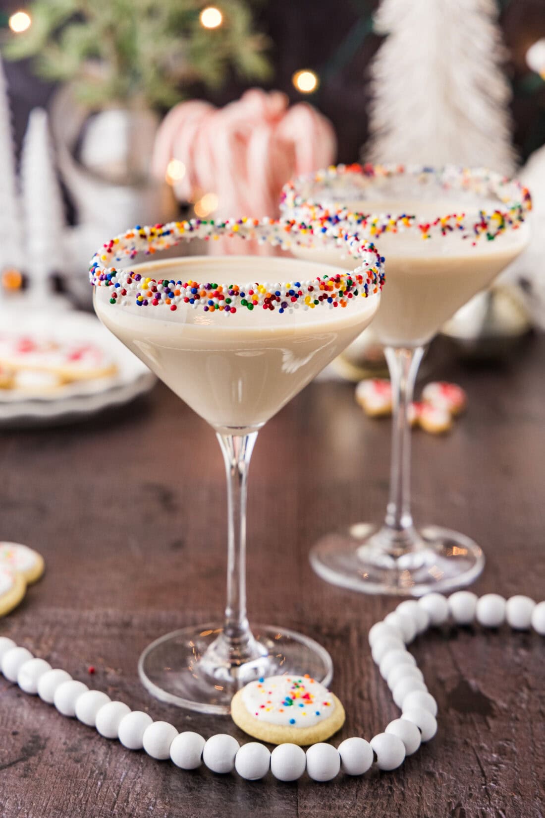 Two Sugar Cookie Martinis surrounded by holiday decorations