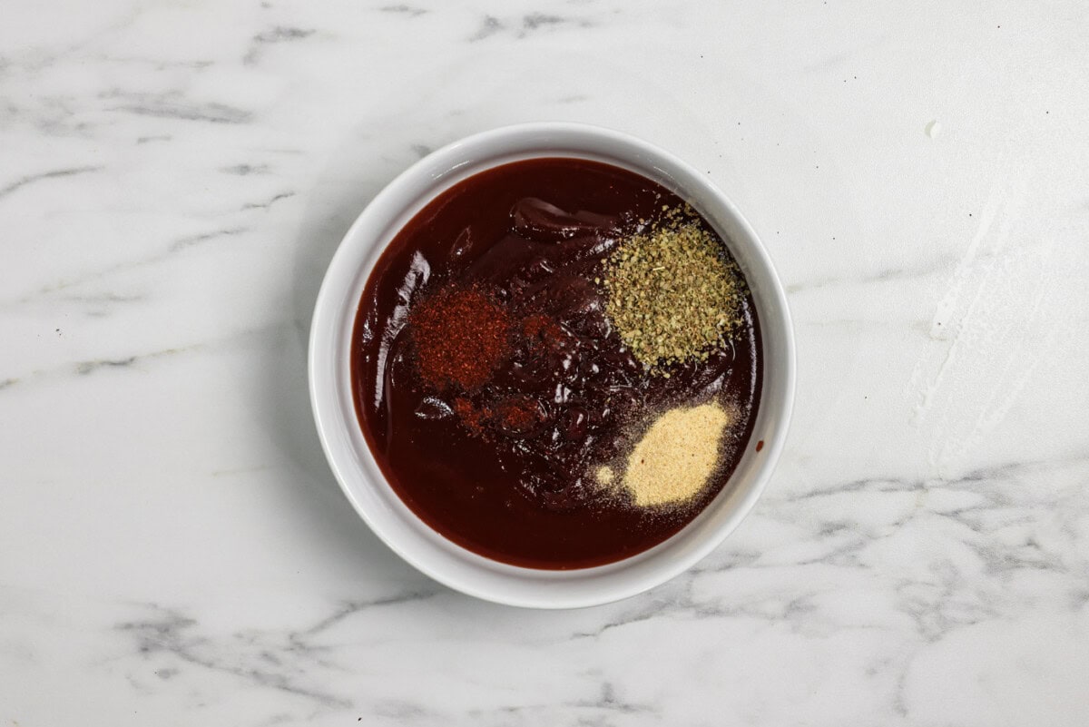 spices and seasonings in a bowl with barbecue sauce