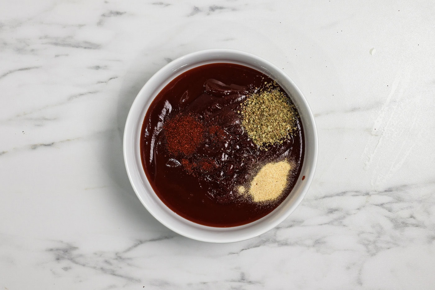 spices and seasonings in a bowl with barbecue sauce