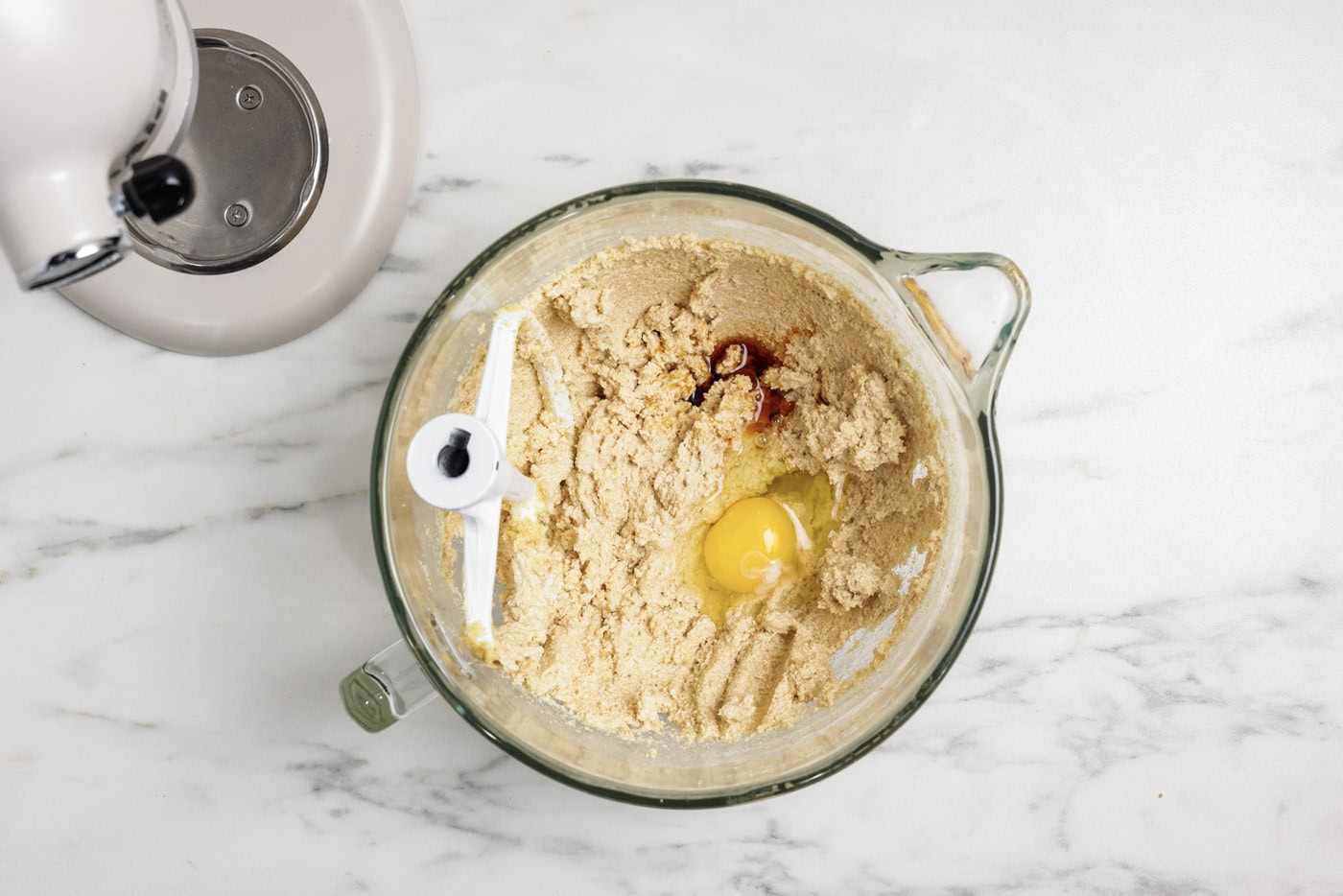 Egg and vanilla added to creamed shortening and sugar mixture