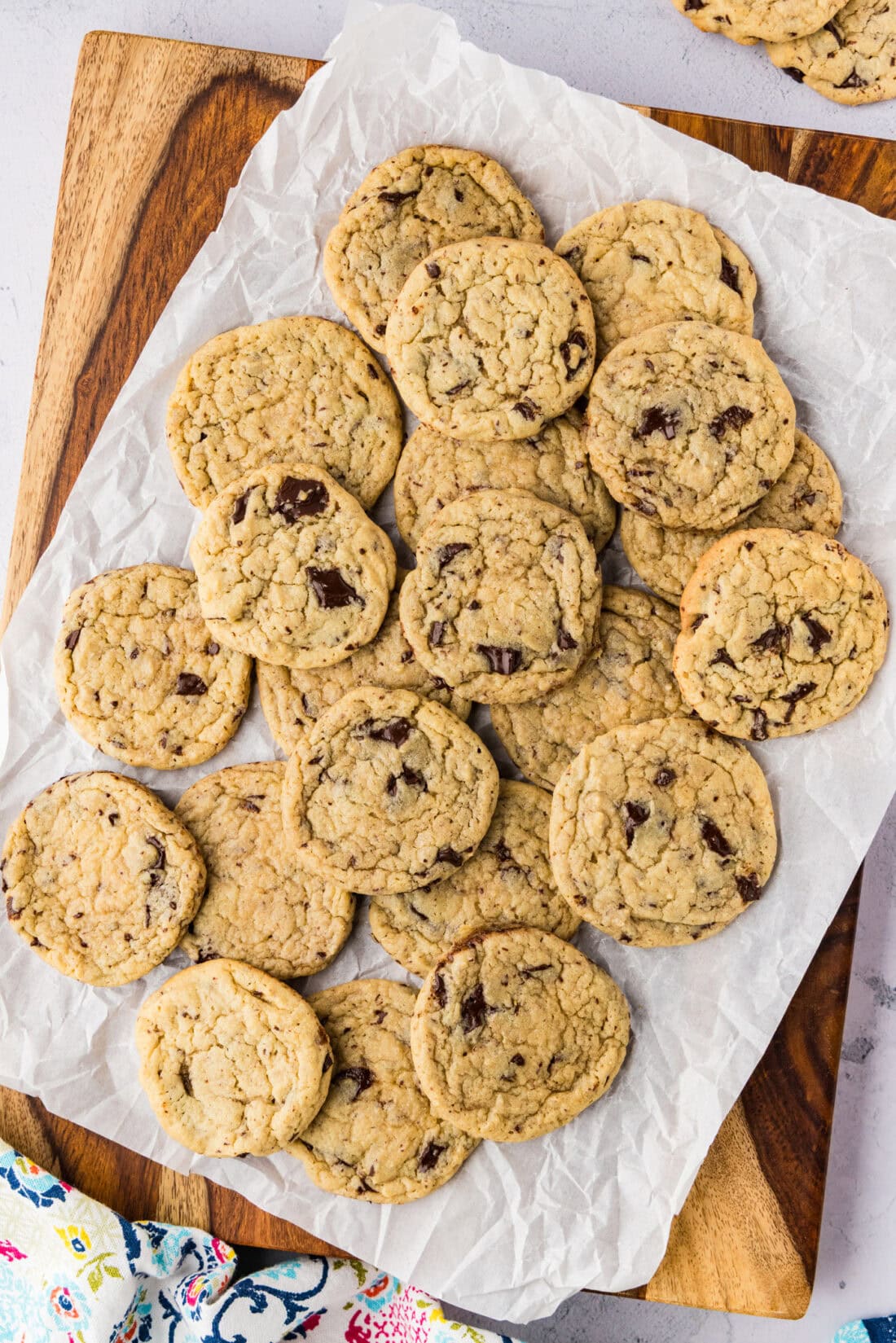 Buttermilk Chocolate Chip Cookies piled on parchment paper