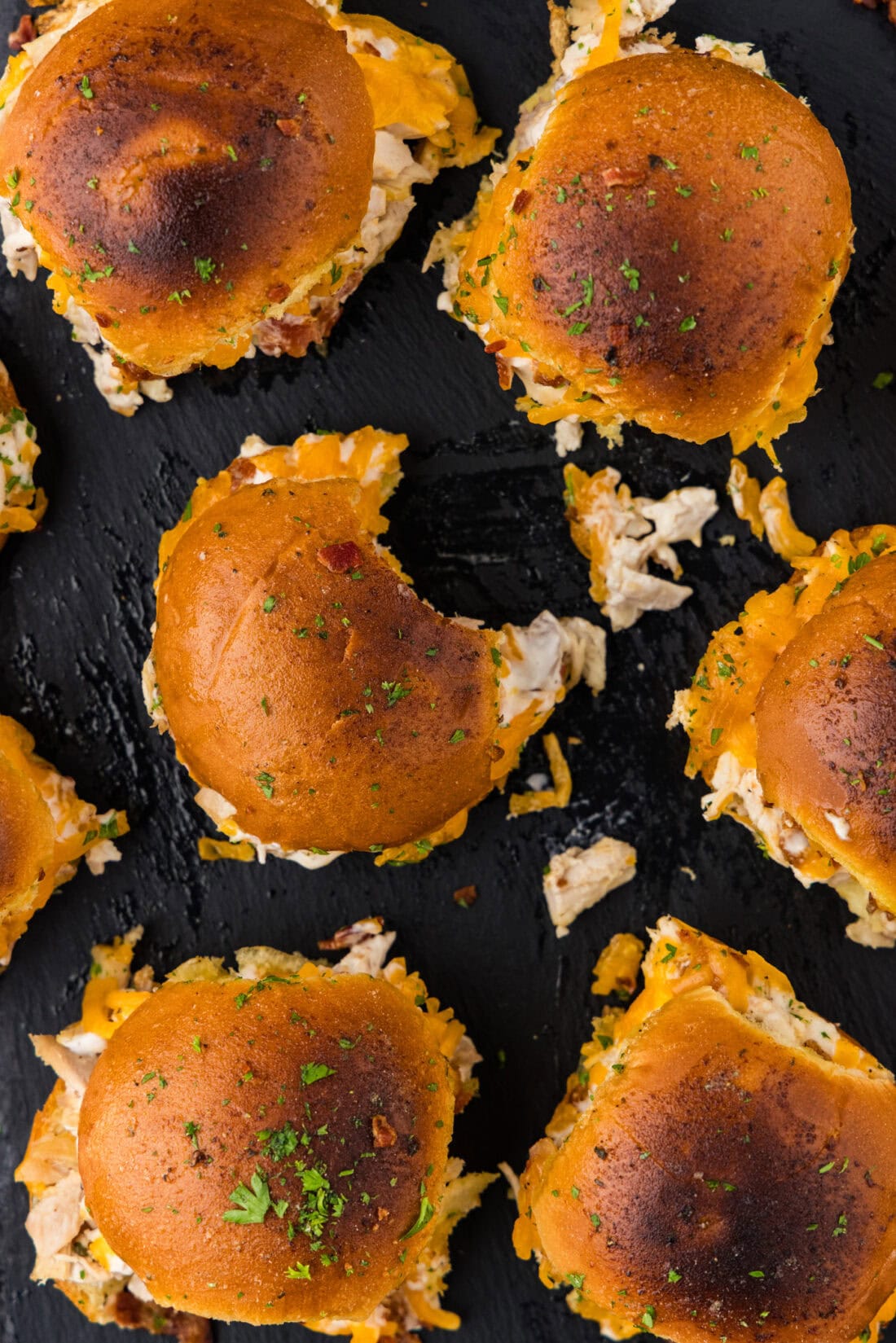 Overhead photo of Chicken Bacon Ranch Sliders with a bite taken out of one