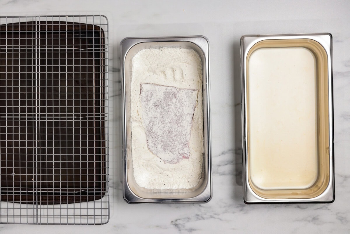 cube steak in a breading tray with flour mixture