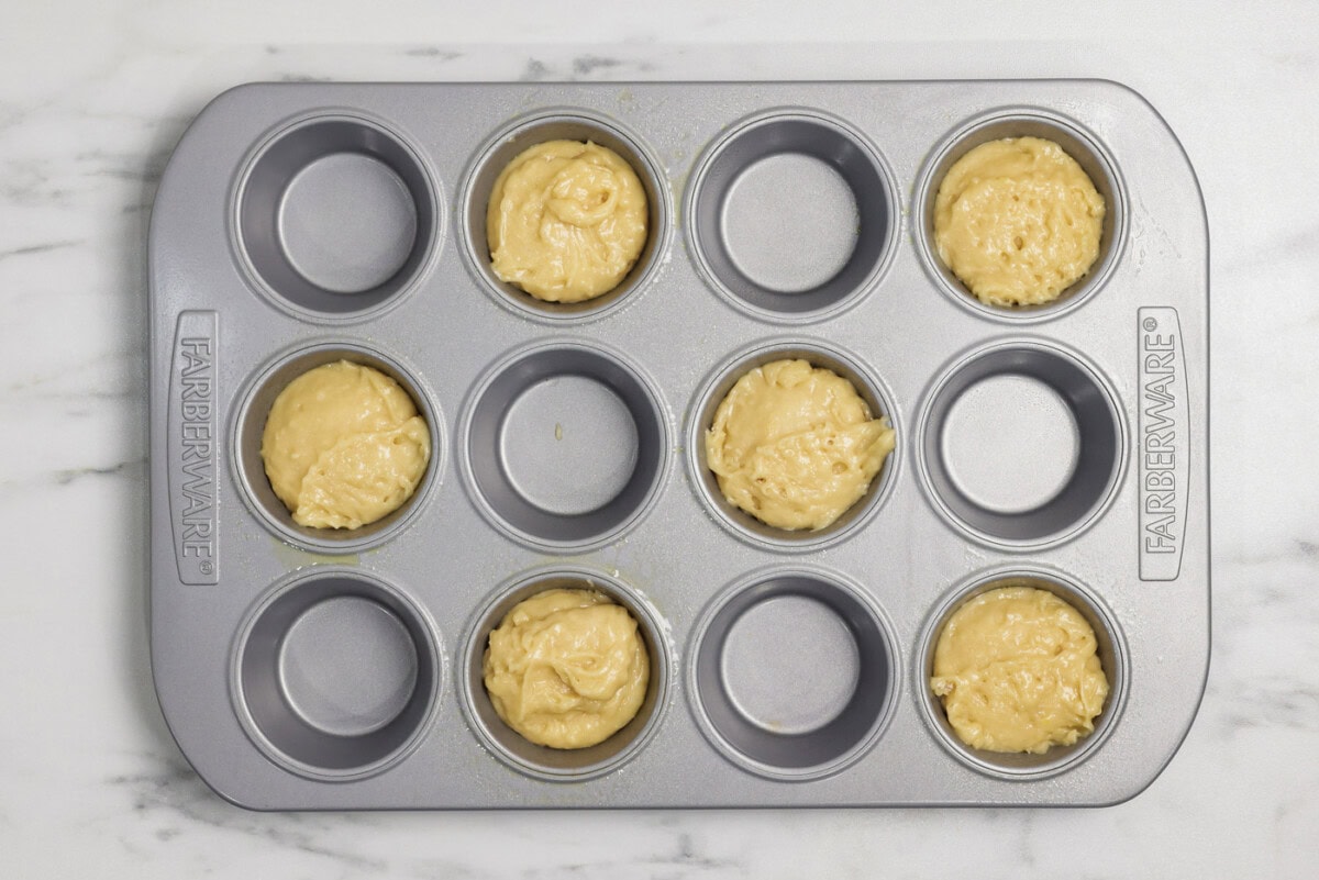 Muffin pan cavities filled with batter