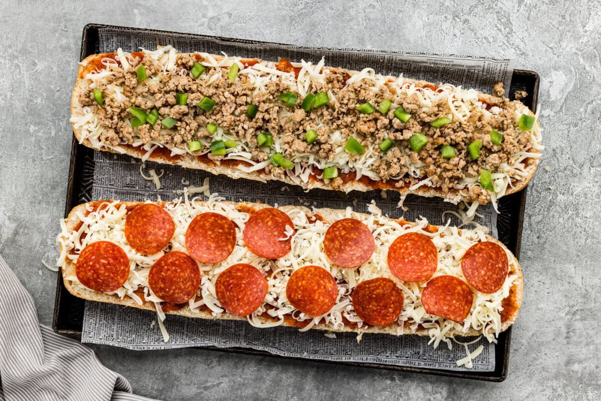 Cheese and pizza toppings added on top of French bread slices