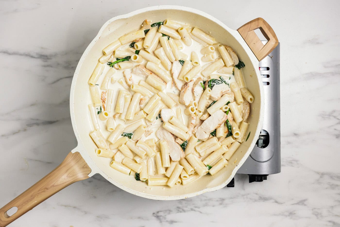 Creamy garlic chicken pasta in a skillet
