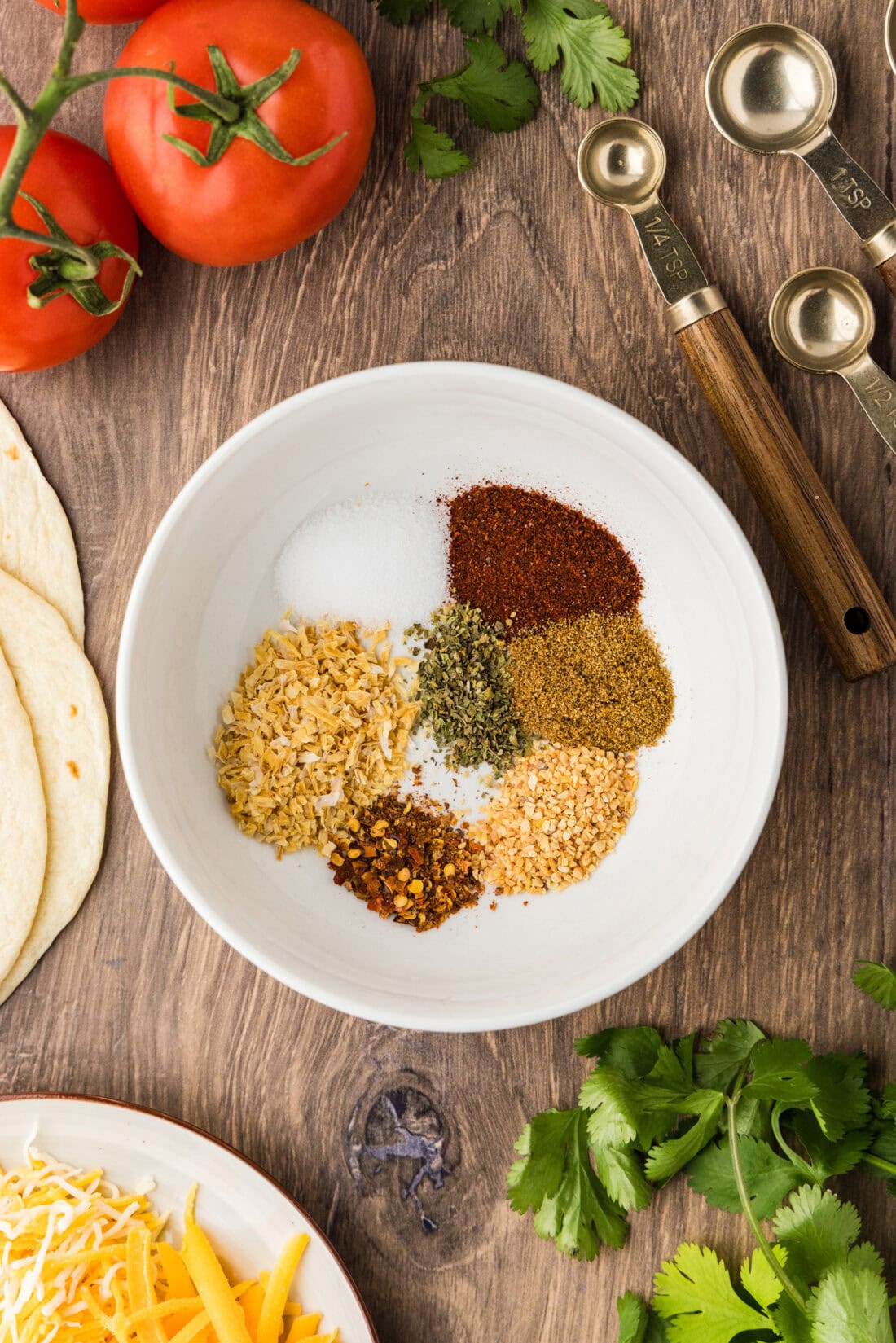 white bowl with ingredients for making taco seasoning