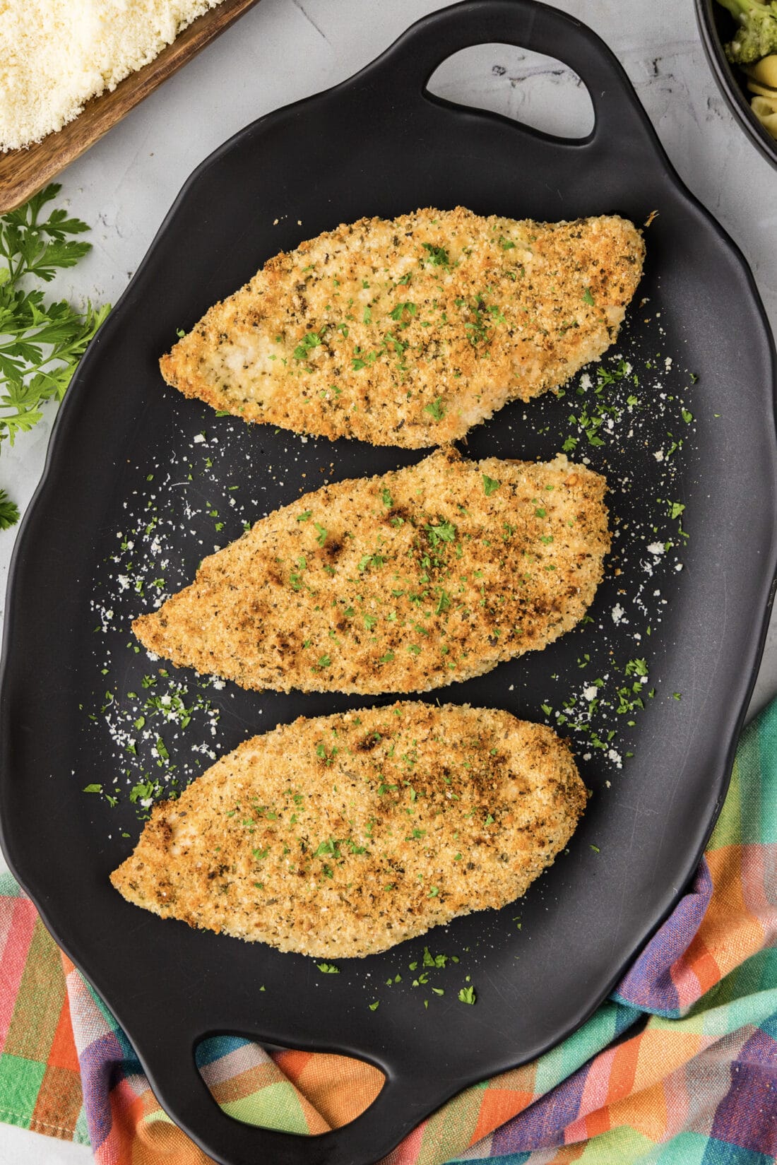 Platter of three Parmesan Crusted Chicken breasts
