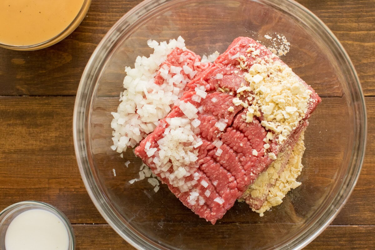 ground beef in a bowl with crushed saltines, onion, 