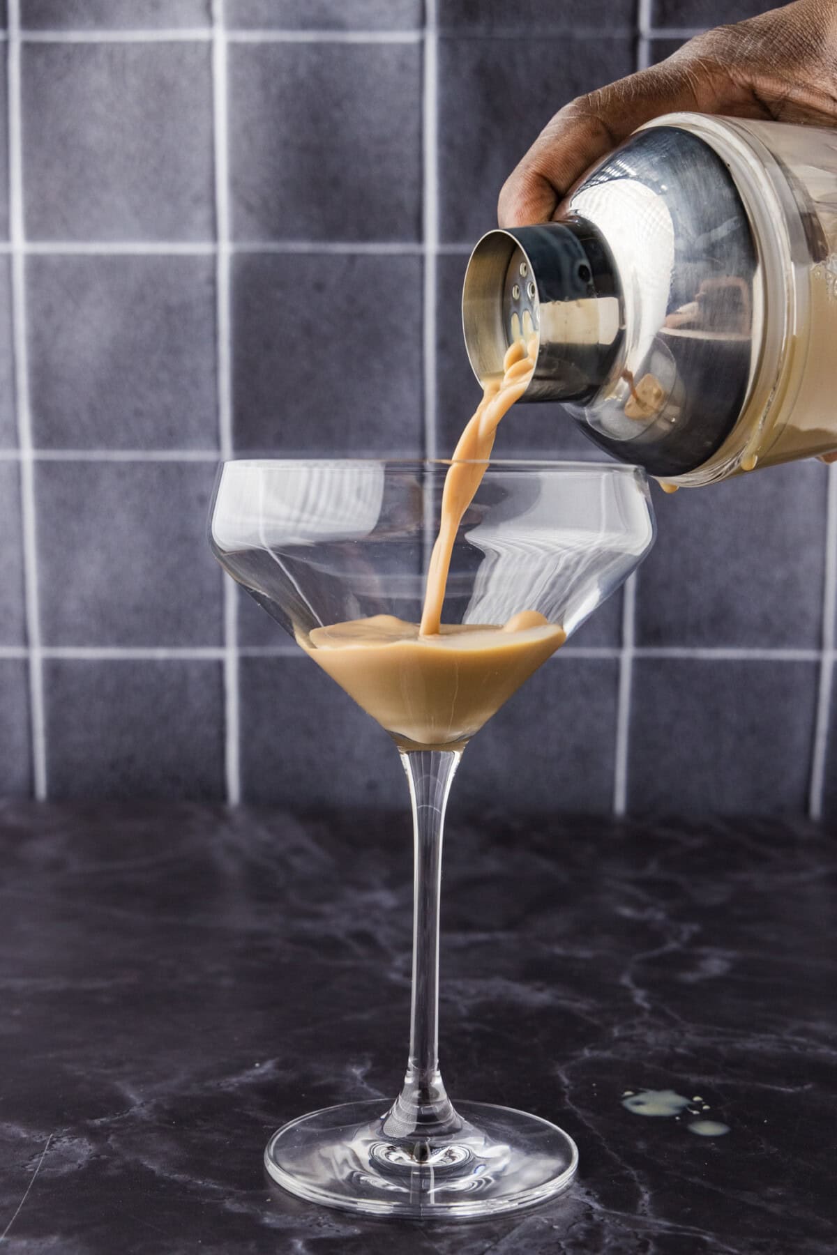 Straining baileys chocolate martini into a glass