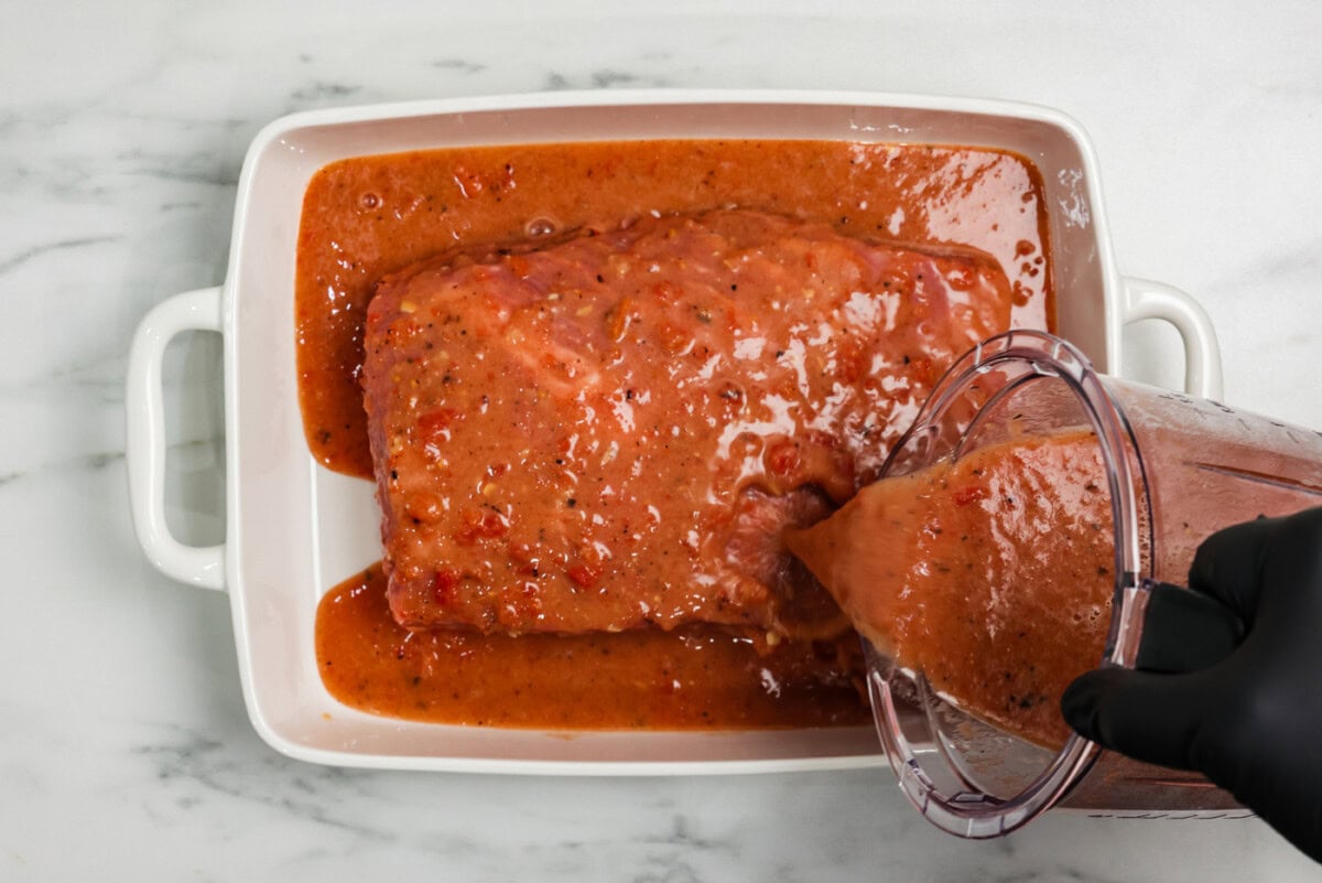 pouring gravy mixture over brsket