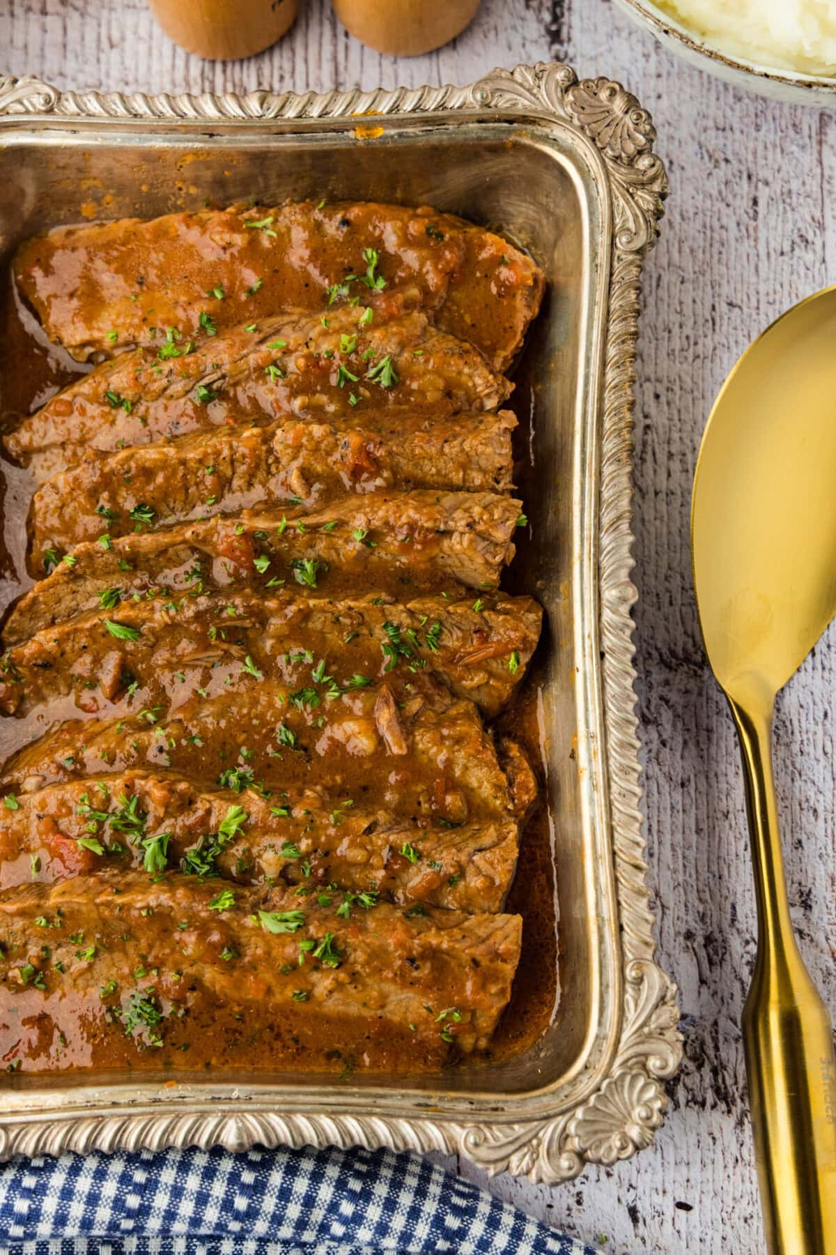sliced beef brisket and gravy in a platter