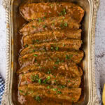 sliced beef brisket and gravy in a dish