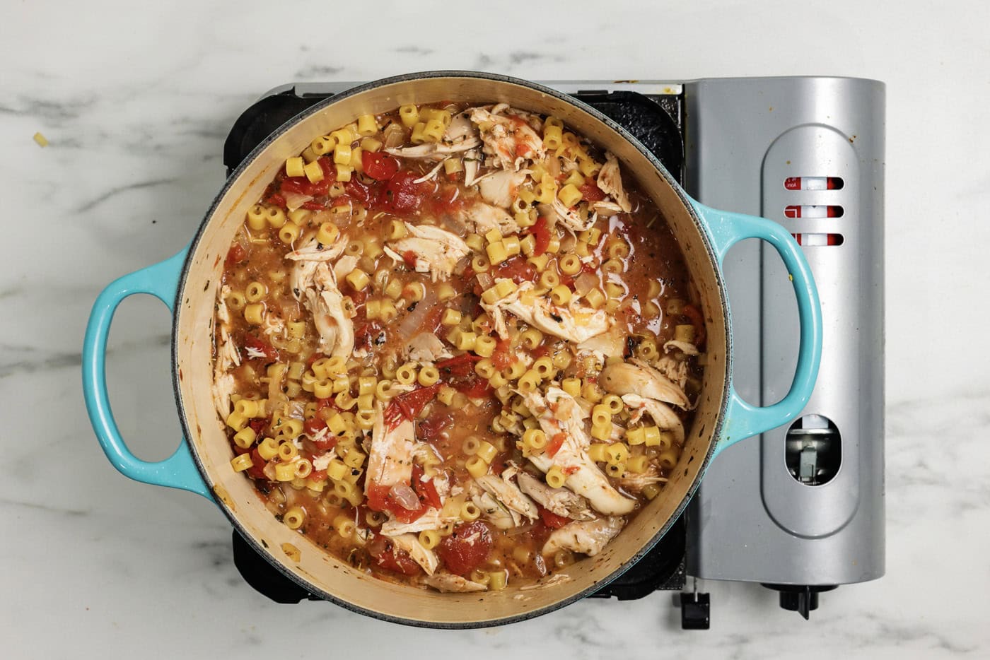 Ditalini pasta added to pot with chicken parmesan soup