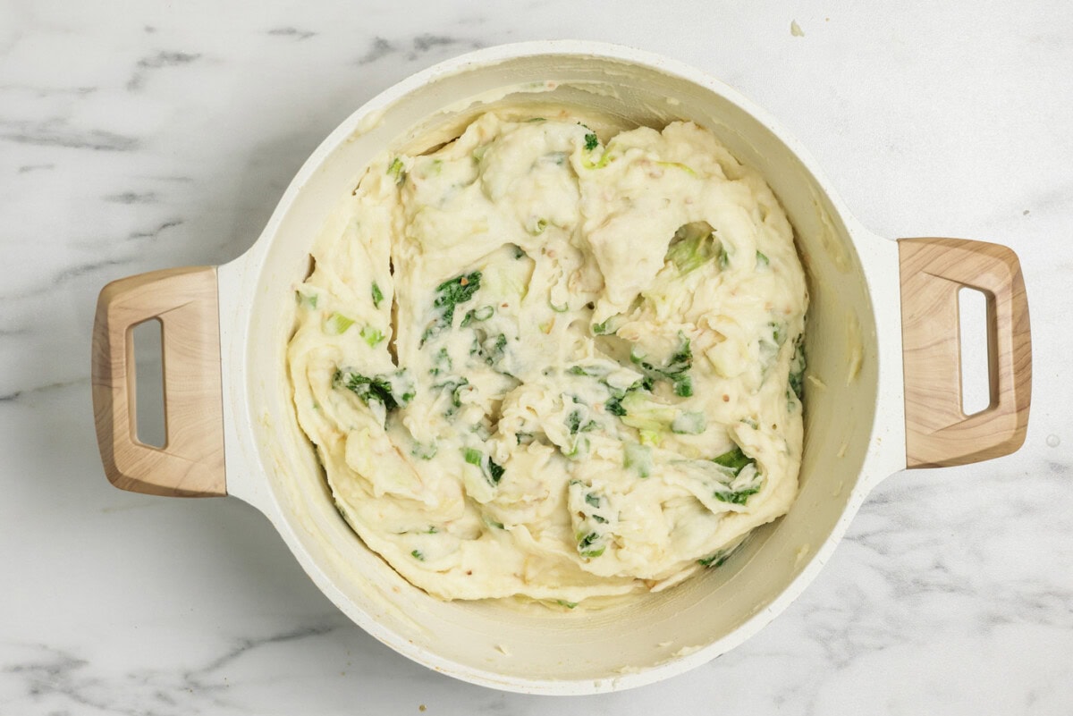 Colcannon mashed potatoes in a stockpot with cabbage and kale
