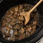 Close up photo of a spatula in a crockpot of Crockpot Beef Tips and Gravy