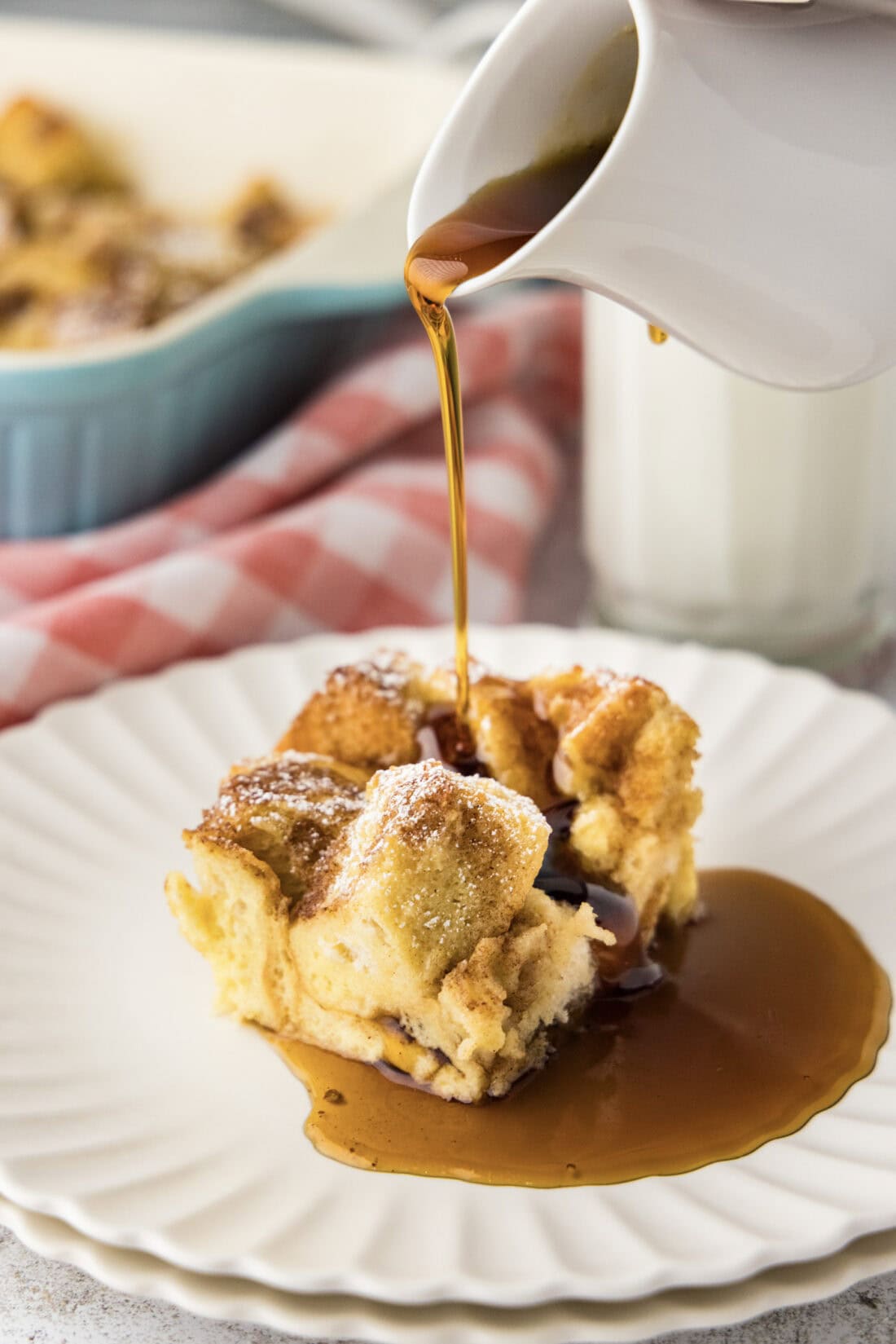 Syrup being poured over a slice of French Toast Casserole