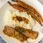 Slow Cooker Balsamic Carrots plated with mashed potatoes and brisket