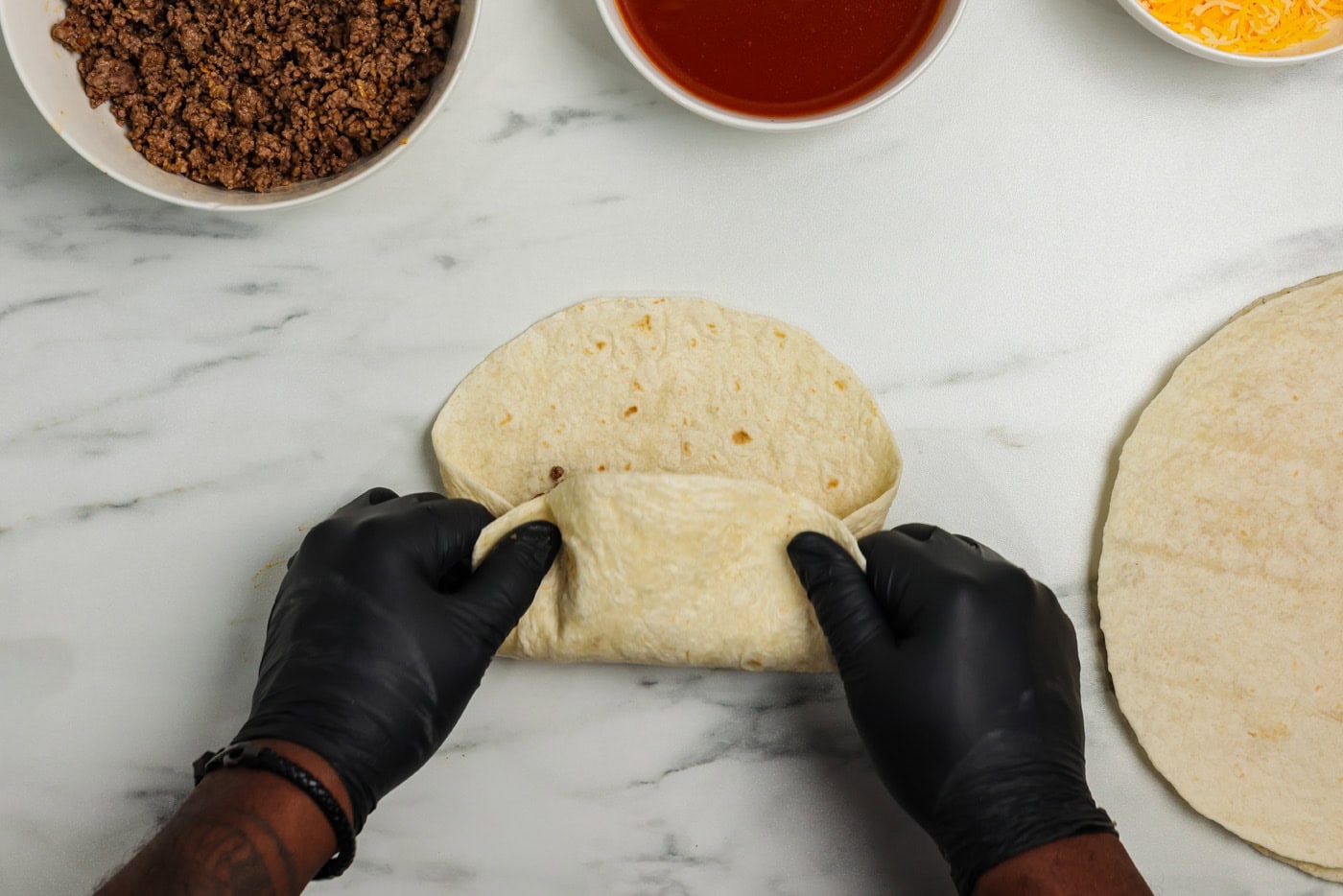 hand rolling tortilla burrito style