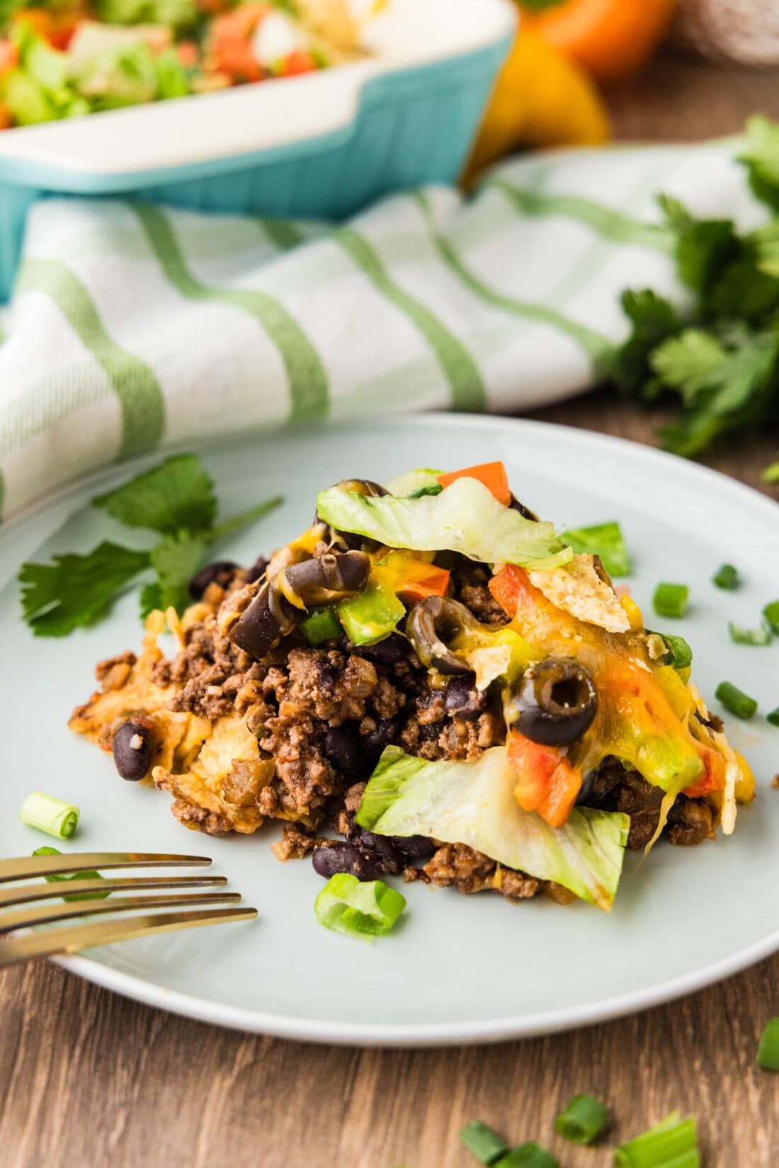 Close up photo of a serving of Taco Casserole on a plate