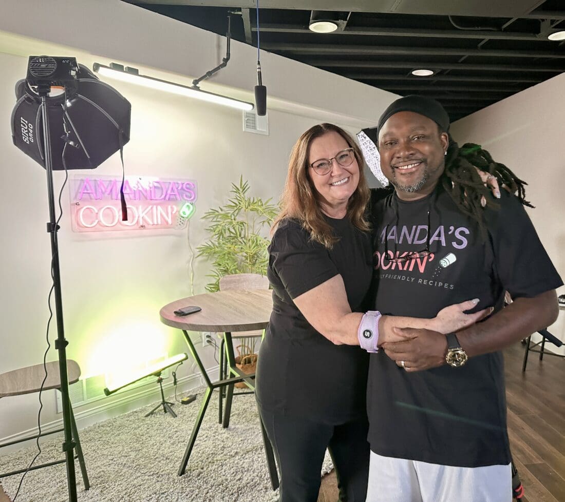 Amanda and Antoine standing in front of the A Squared set