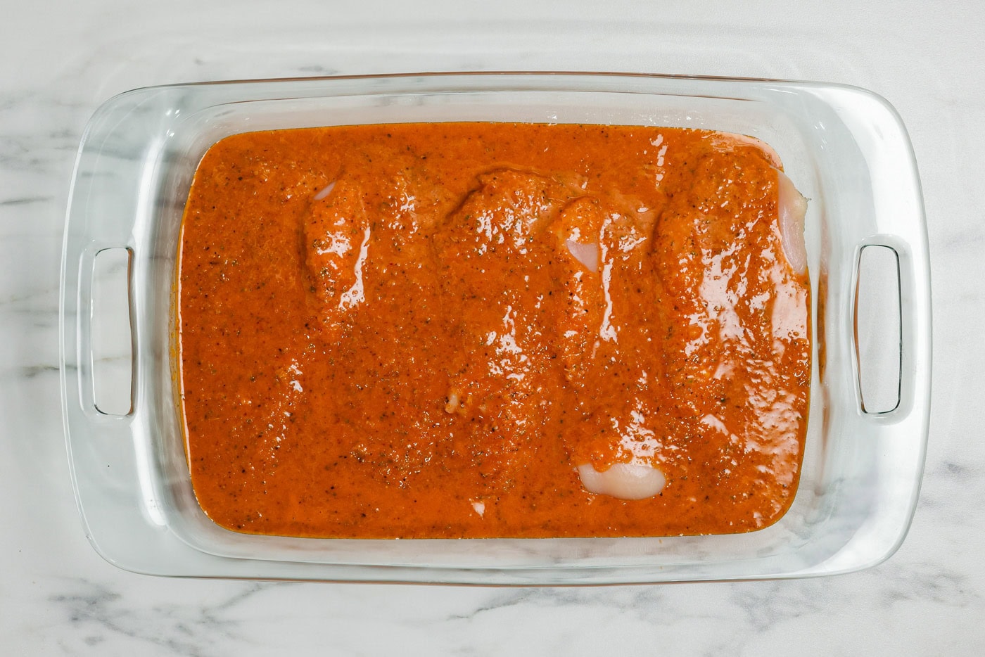 chicken covered in marinade n pan