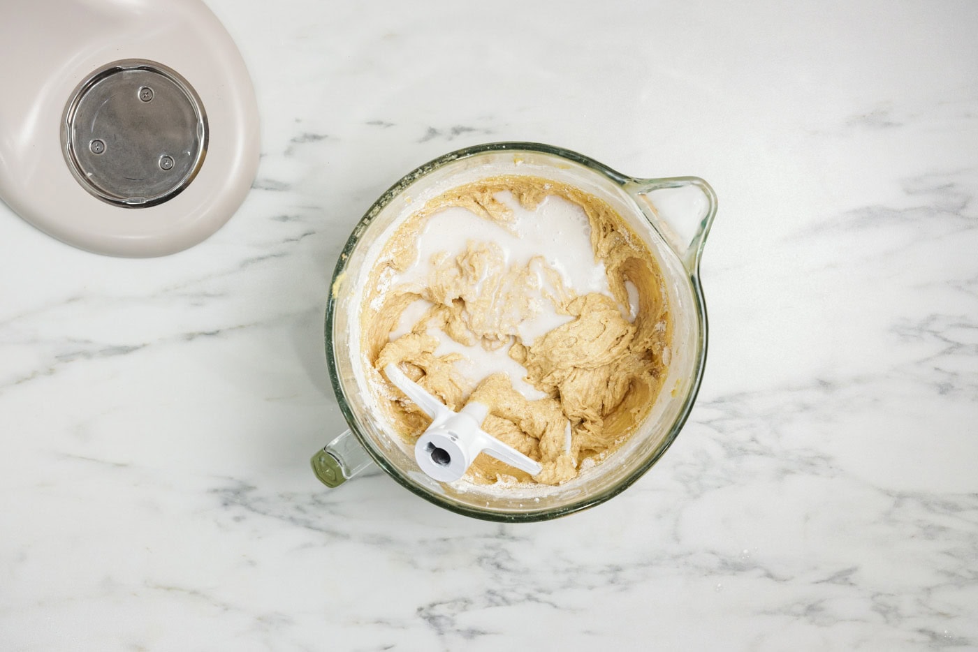 coconut milk added to cake batter in bowl