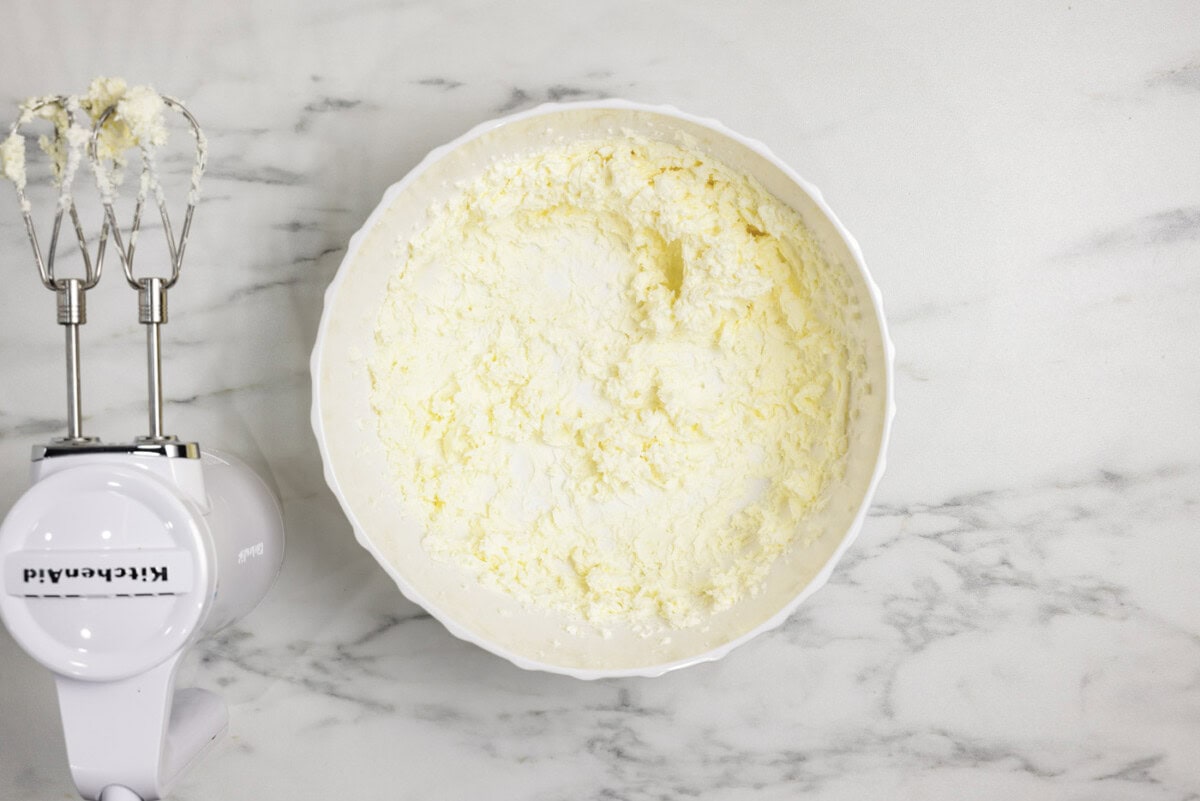 butter and cream cheese beaten in a bowl with a hand mixer