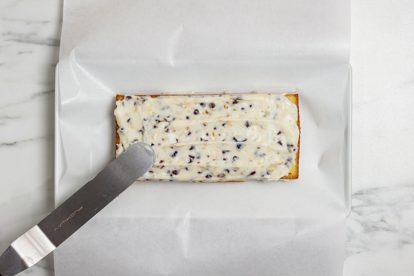 spteading ricotta filling on pound cake layer