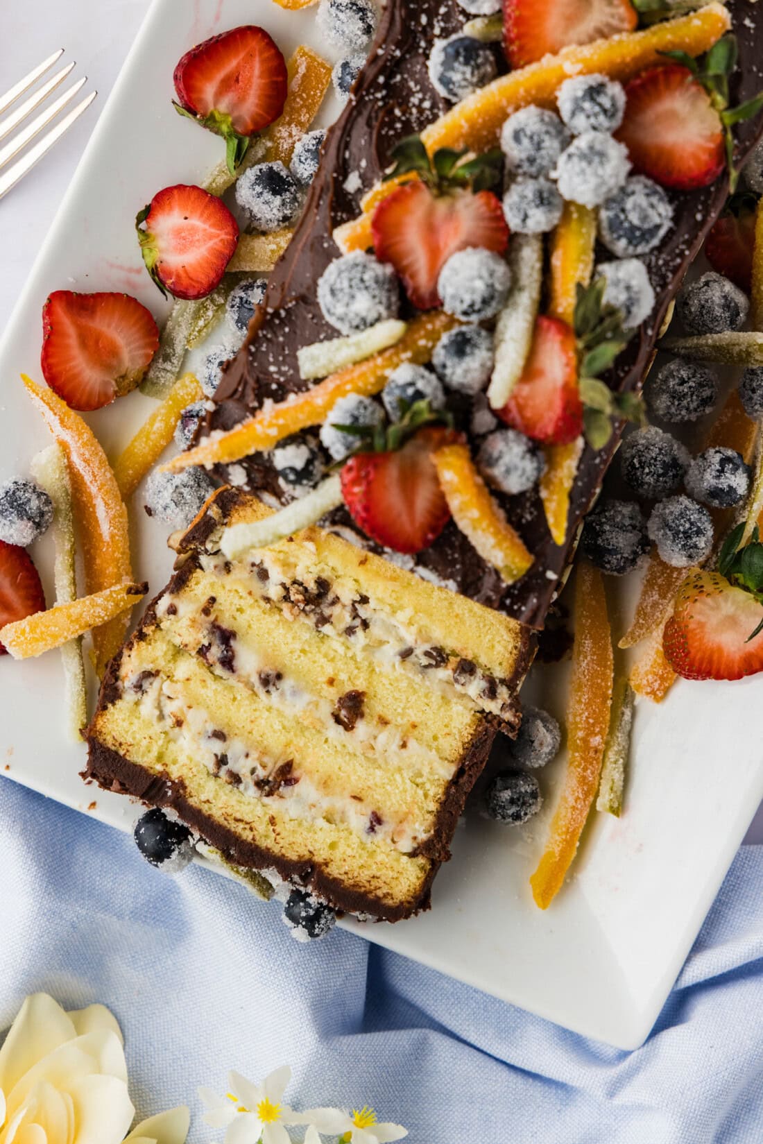 sliced chocolate covered cassata cake with candied fruits