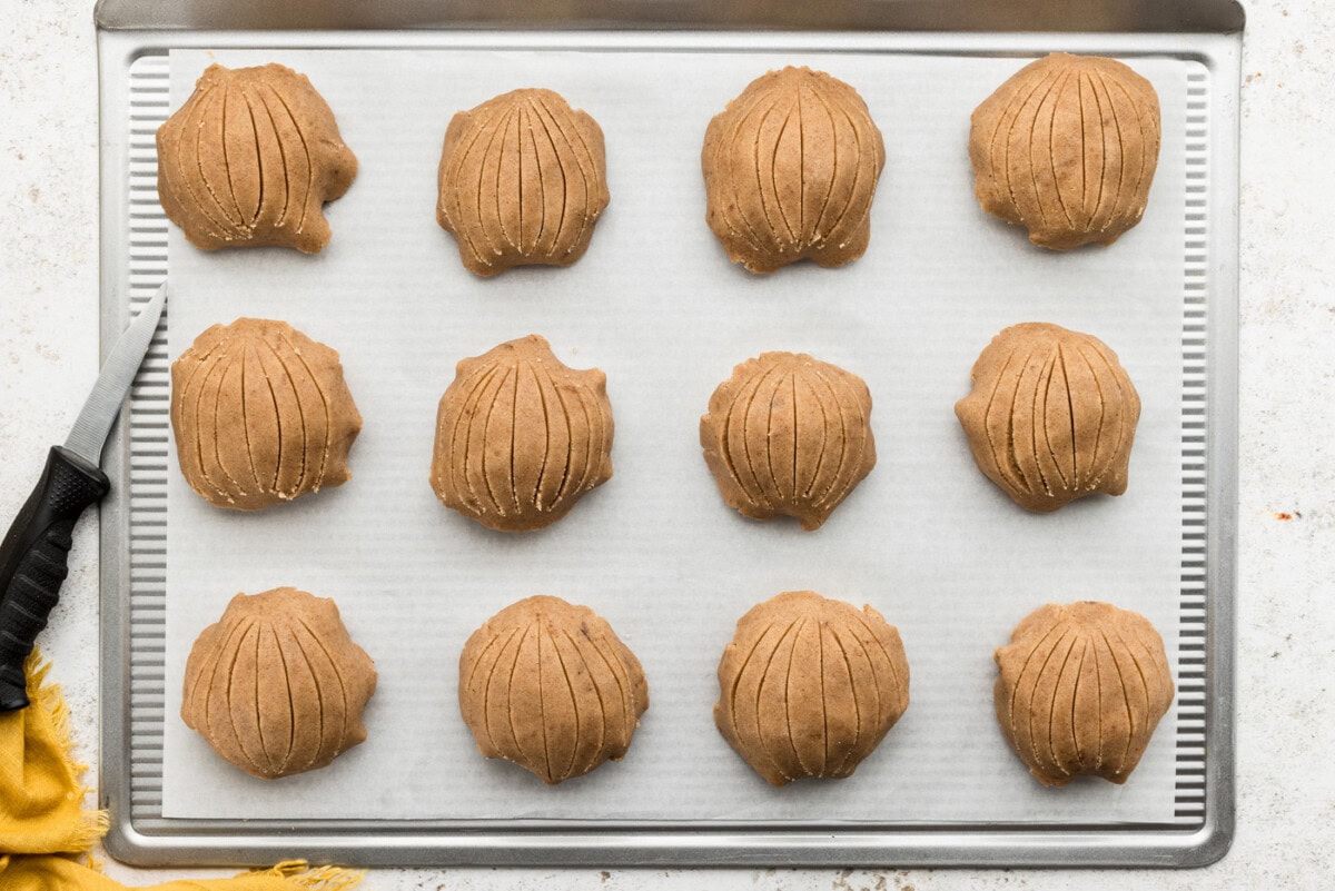 Unbaked conchas on a baking sheet with sugar topping