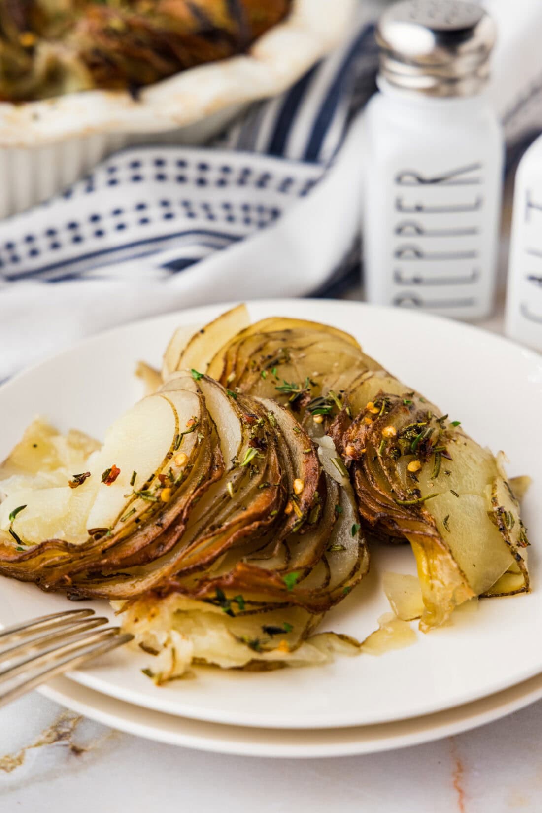 Serving of Crispy Roast Potatoes on a plate with a fork