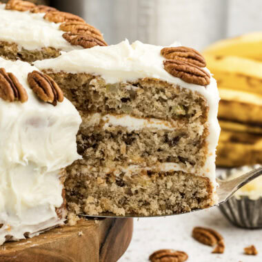 Close up photo of a slice of Hummingbird Cake being removed