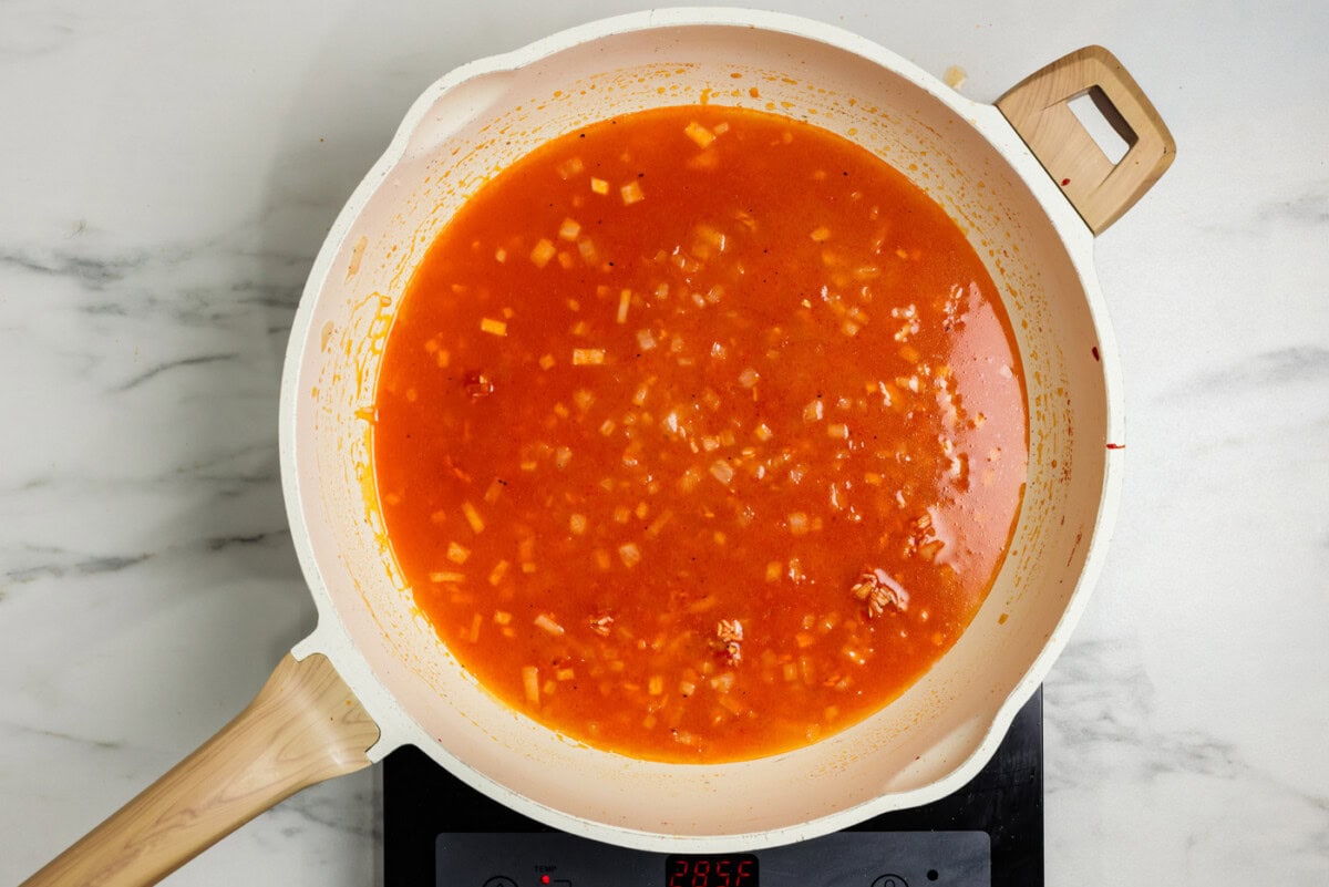 broth and tomato mixture in skillet