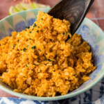 serving spoon lifting Mexican Rice
