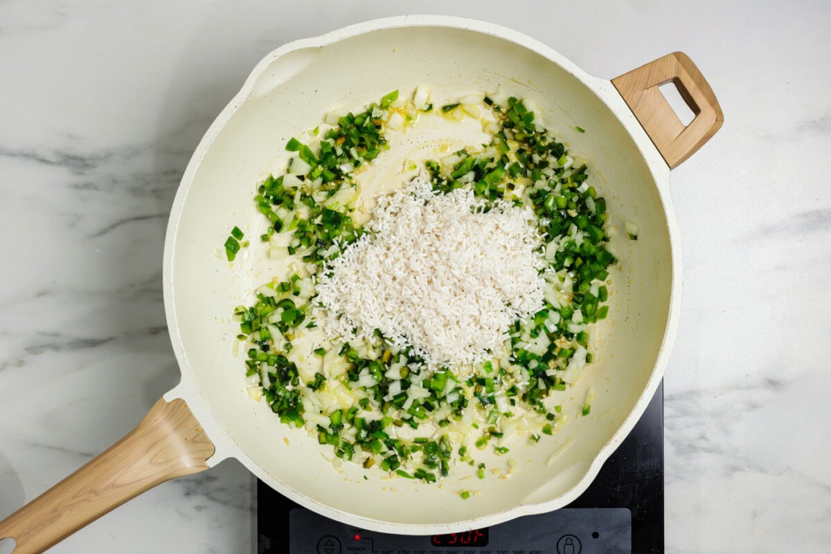 rice in skillet with sauteed vegetables