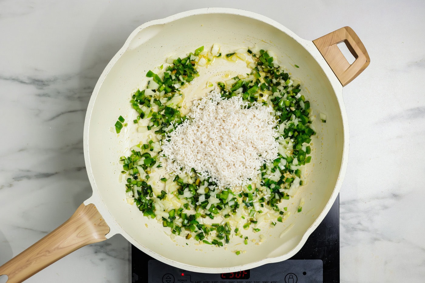 rice in skillet with sauteed vegetables