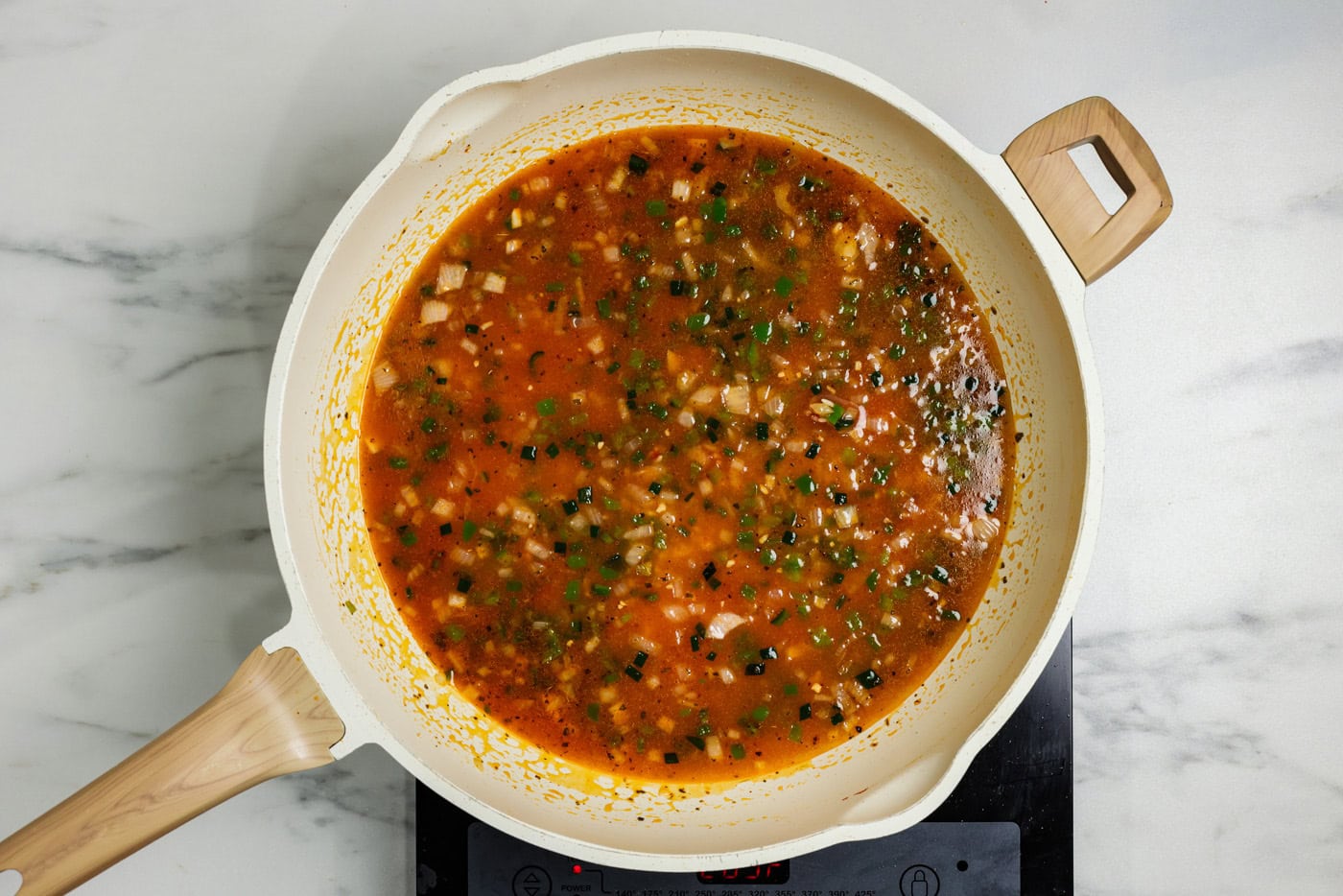 broth and tomato mixture in skillet