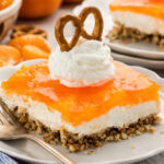 Orange Pretzel Salad on plate with whipped cream