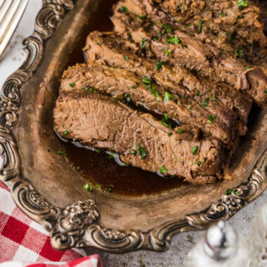 Slices of Slow Cooker Brisket on a silver platter