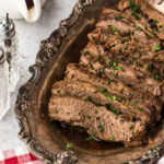 sliced brisket made in crockpot on a platter